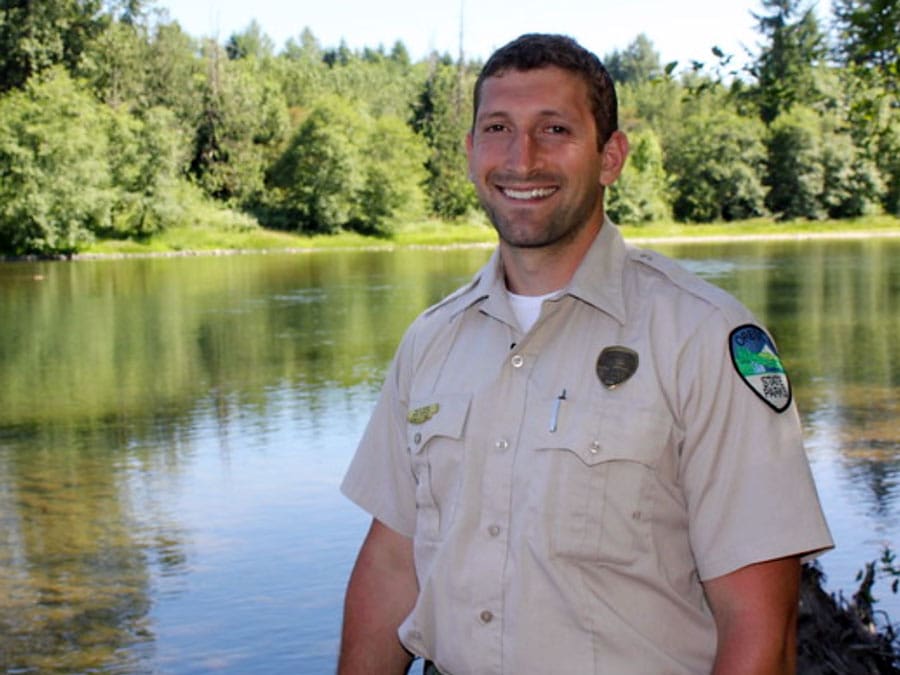 State employee standing by a body of water